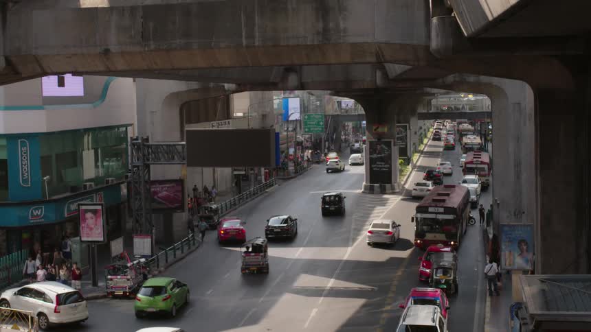 Cars drive on a city street