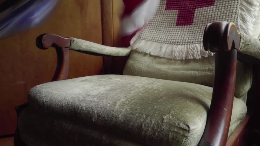 Folded american flag is removed from a chair