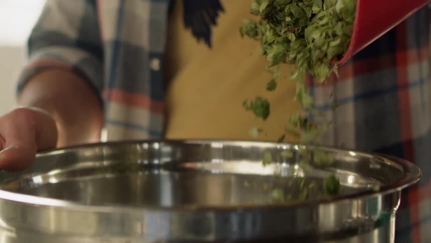 Greens are poured into a silver pot