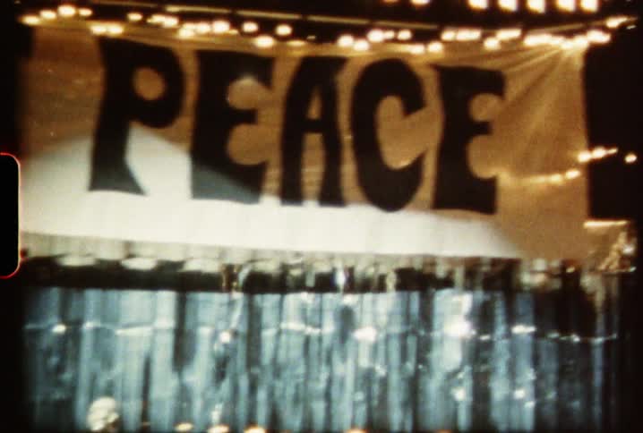 The bright stage has a banner above