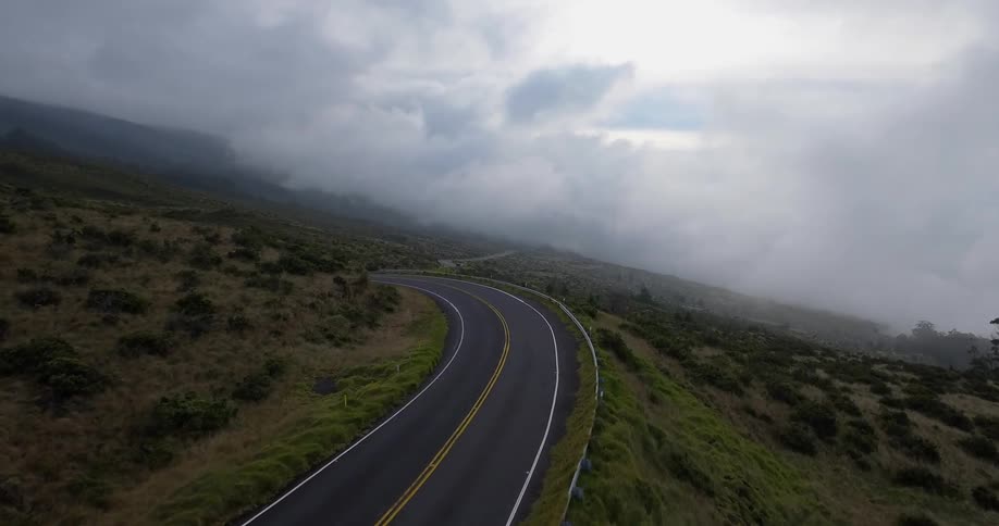 Dense fog clouds in the distance on a mountain road