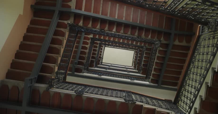 The inside of a building and the staircases and it is spinning to show the staircases