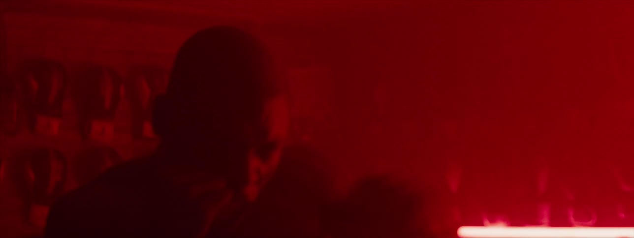 A boxer shadow boxes in the dark gym