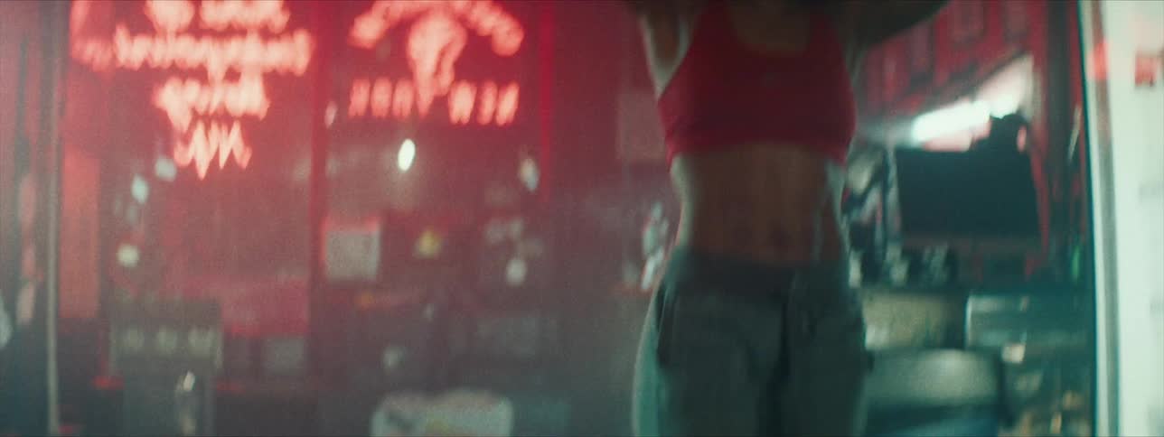 A woman trains in a gym with ropes