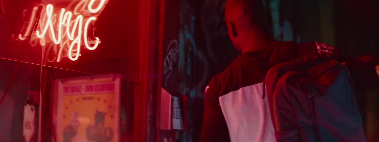 Man and woman enter a building at night