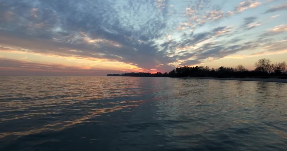 Passing view of a sunset from a moving water vehicle