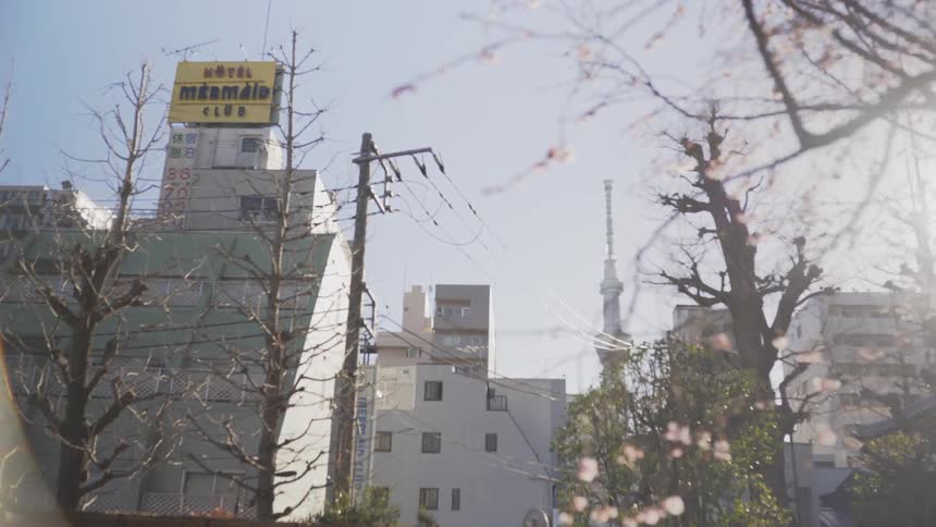 The tall building has a yellow sign at the top