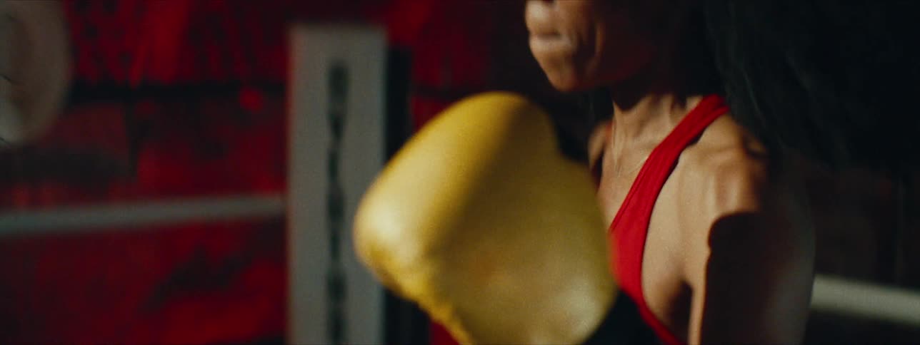 A woman is boxing with a sparring partner