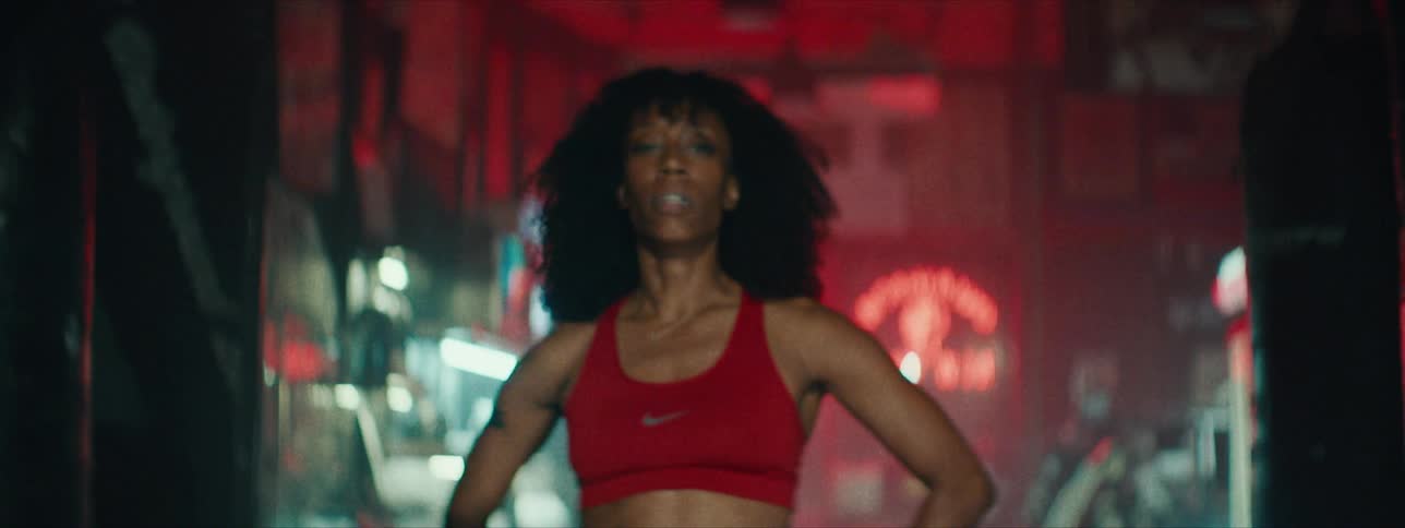 A woman is dancing inside of a barber shop