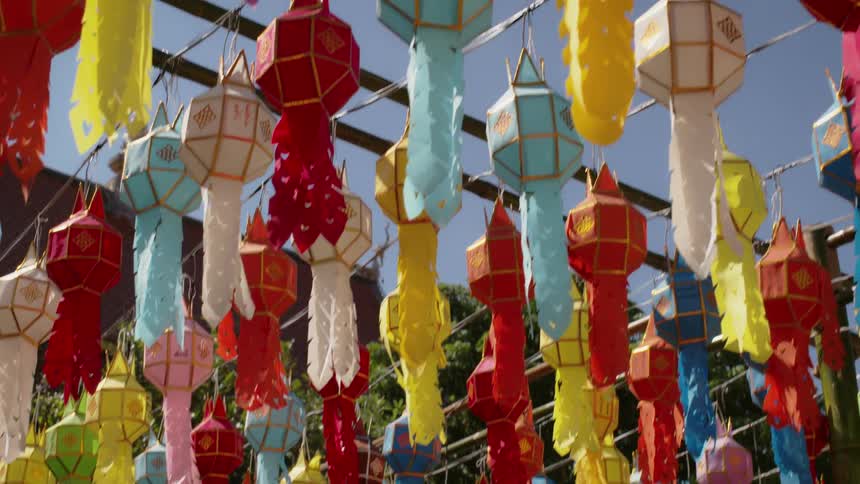Kites hang from string on a sunny day