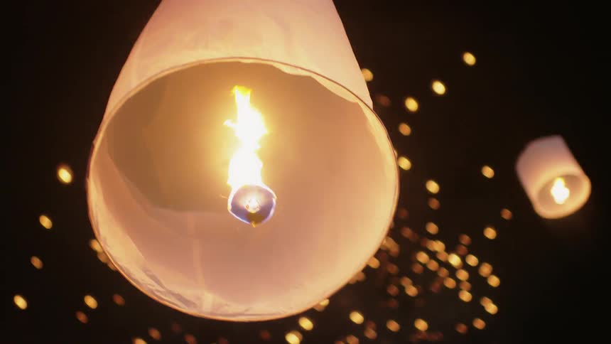 People release paper lanterns into the sky
