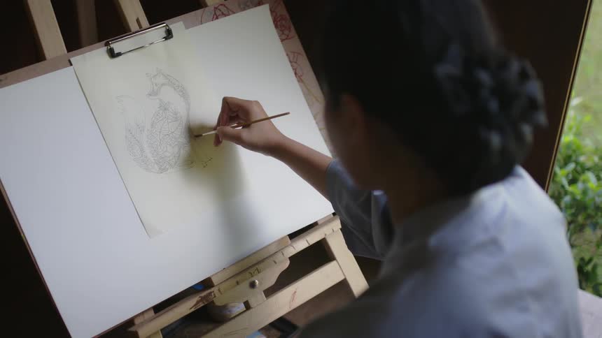 An artist draws on an easel