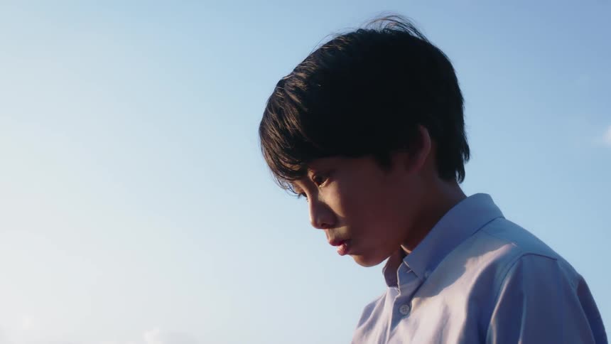 A child looks down on a sunny day