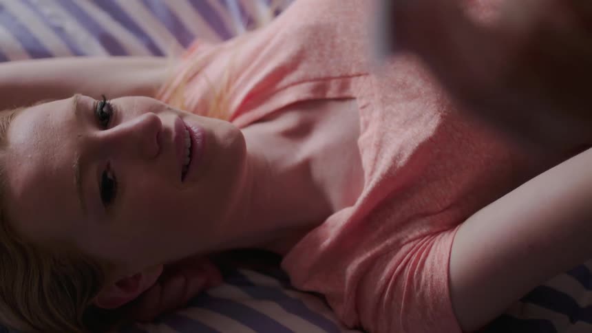 A woman lays in bed
