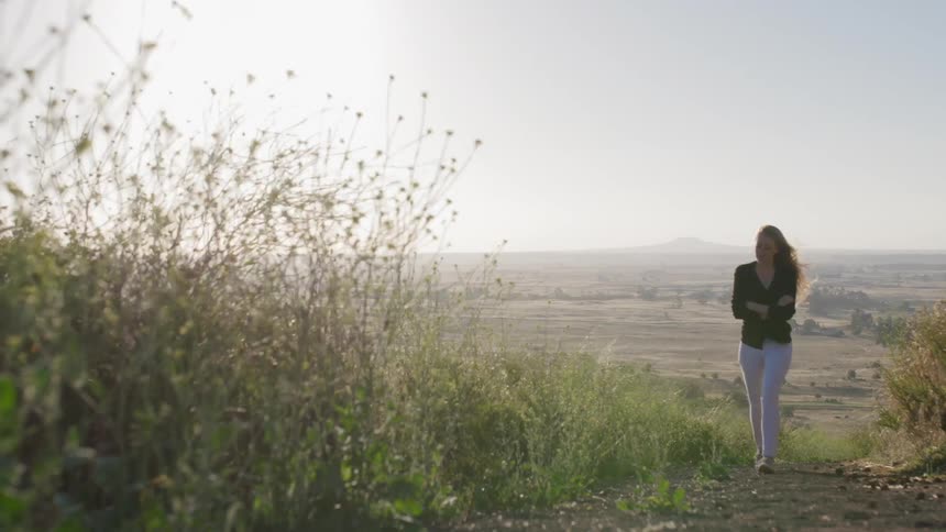 A woman walks up the hill
