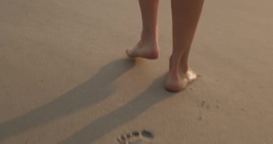 Someone walking along the sand and leaving footprints behind