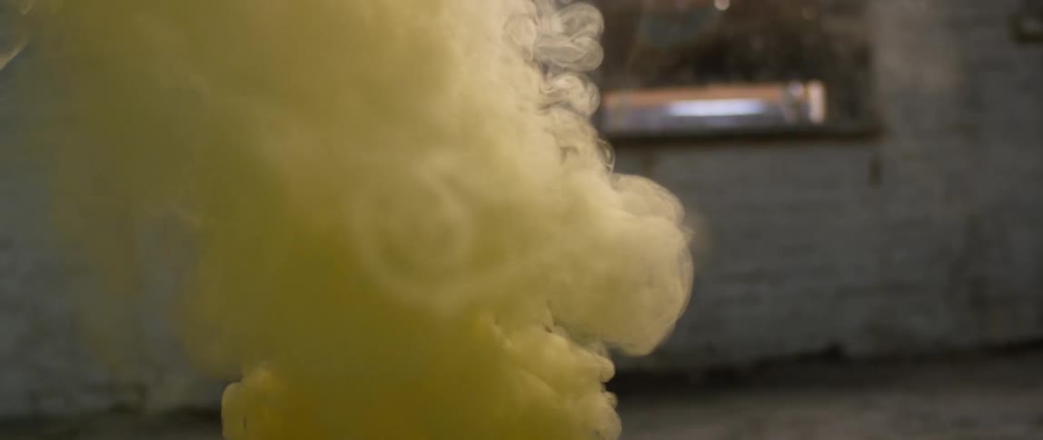 Yellow smoke billows in the air