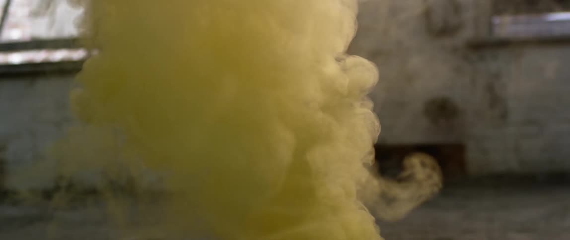 Yellow smoke billows in the air