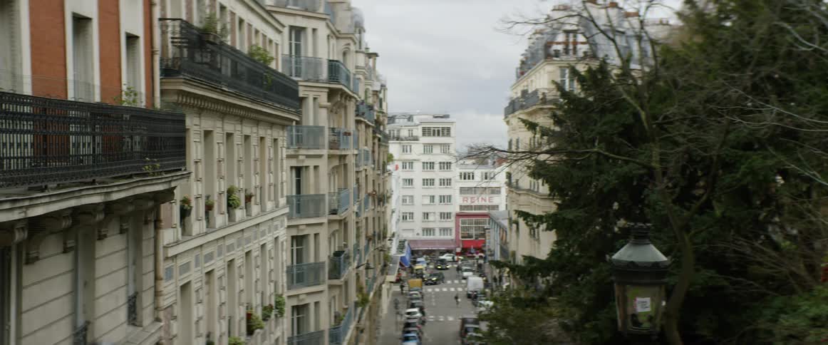 Vehicles and pedestrians travel on the city street