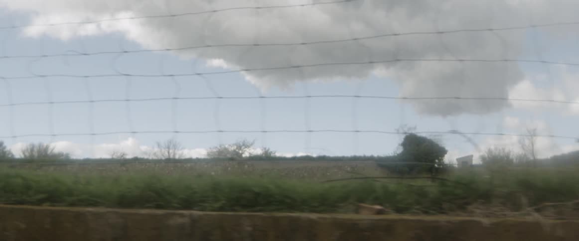 View of the sky through a wire fence
