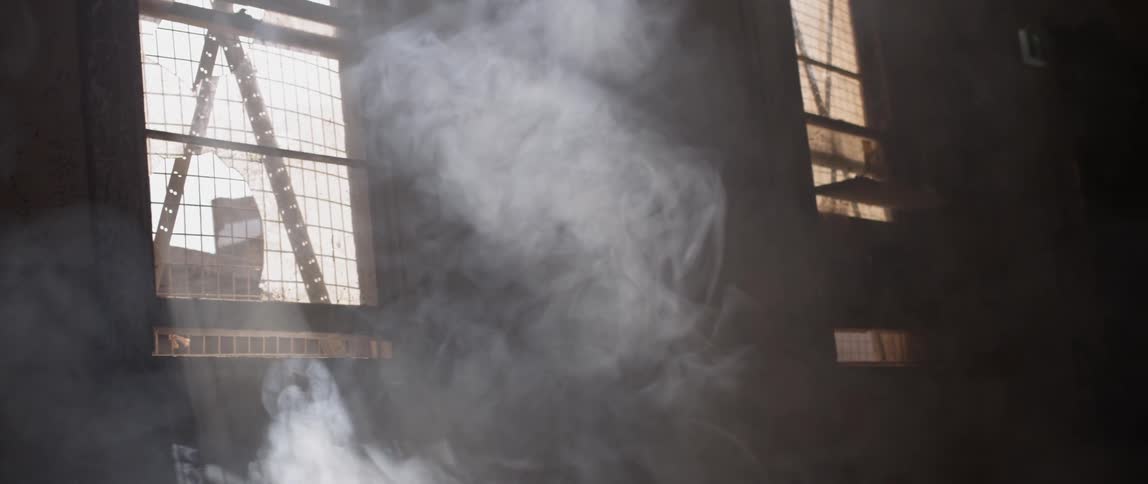 Sunlight coming through a window highlights dust and smoke in the air