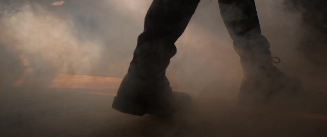 A person walks through smoke