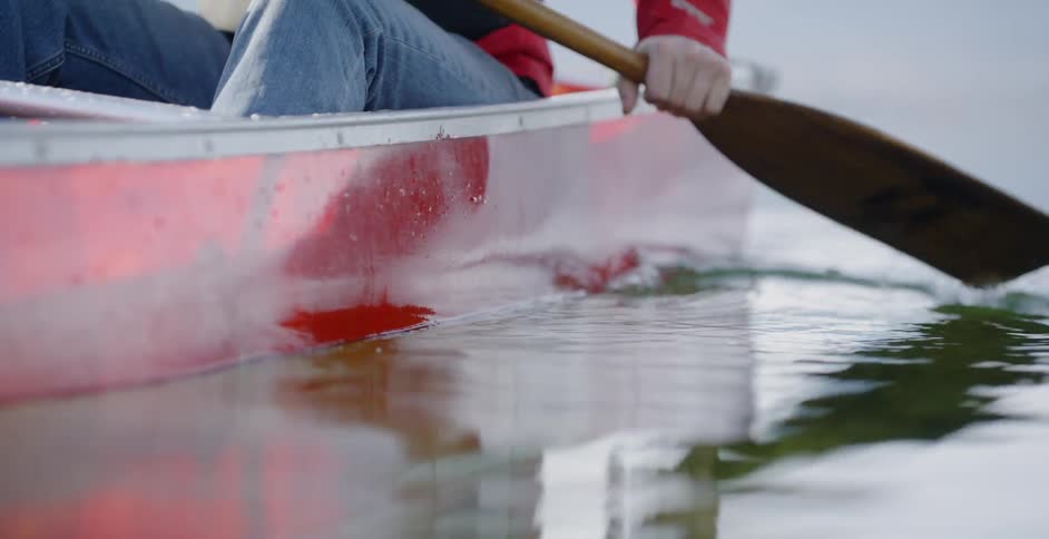 A family canoes on a lake