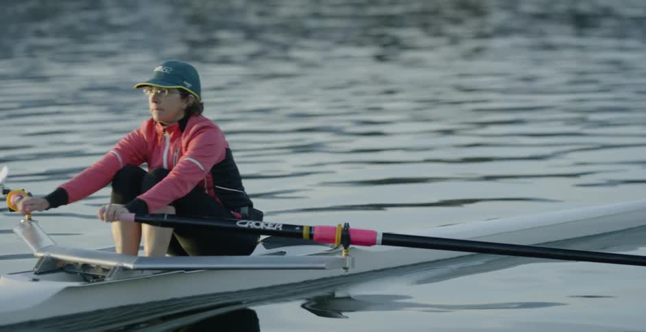 Woman paddles a kayak in a body of water