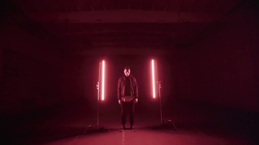 Red lights illuminate a warehouse