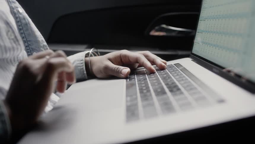 A woman is working on a laptop