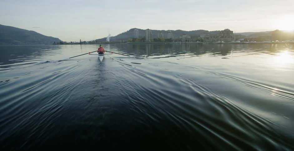 A person rows a boat on the water