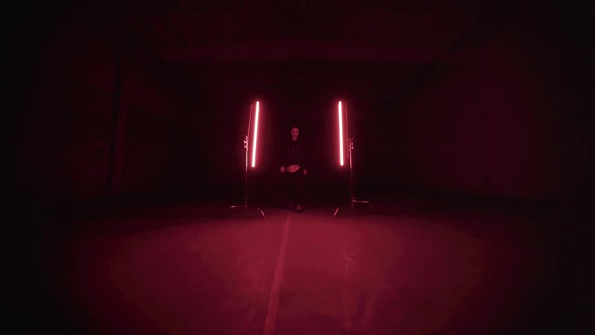 A man walks past the neon lights