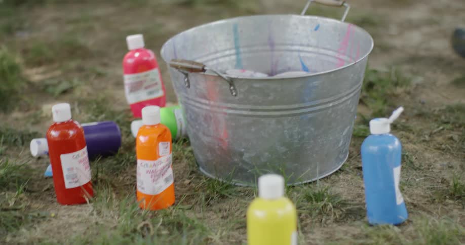 Colored bottles sit next to a tub of water