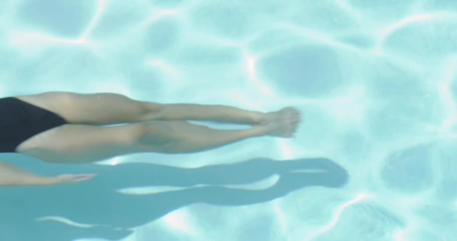 Woman swims on her back in the water