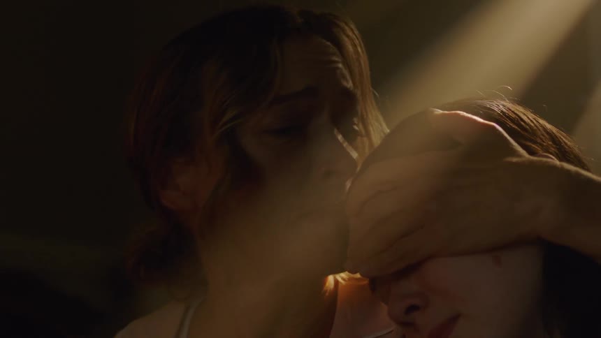 Woman sitting on the floor with two children looking scared