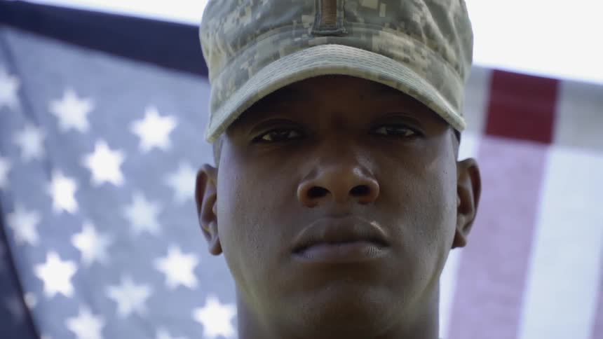 Man in military cap gazes forward