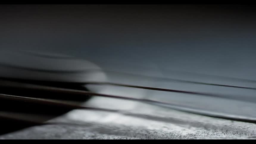 A man strums guitar strings with his finger