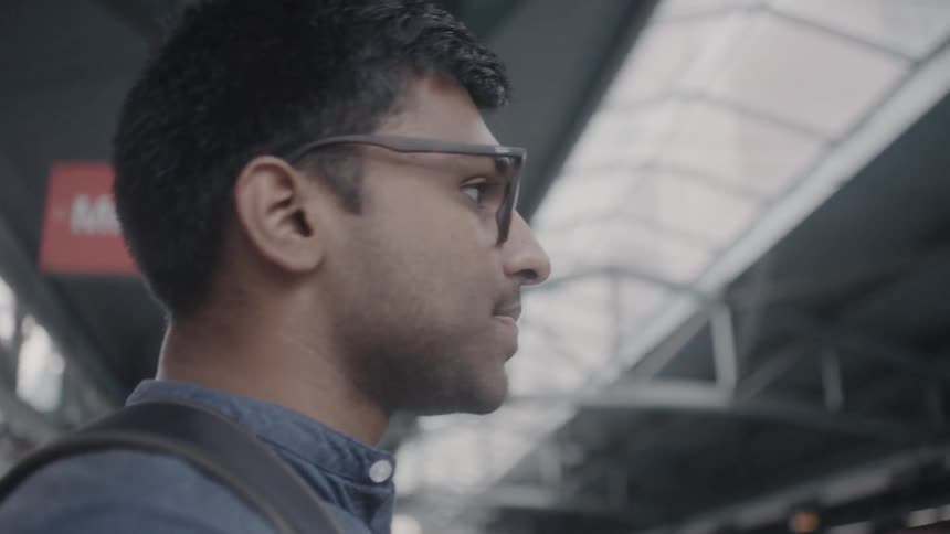 Man stands in an airport looking around