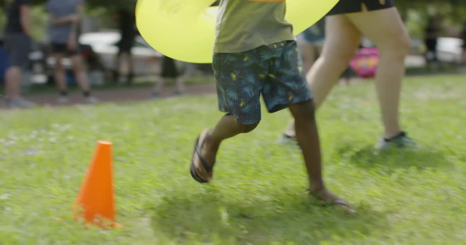 A child runs with a plastic tube around him