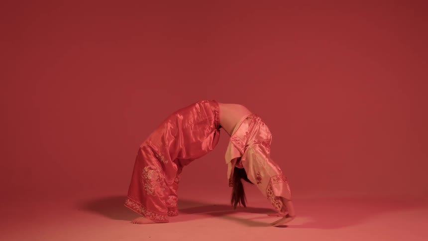 Woman lays on her back on the floor then does a backbend