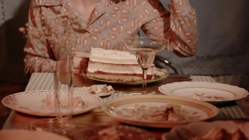 A woman eats a large piece of cake