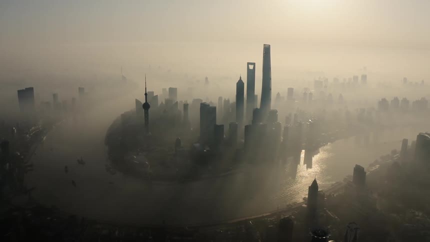 Sunlight shines through fog in a city