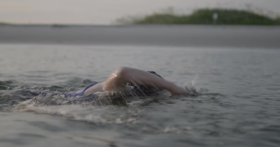 Woman swims in a lake