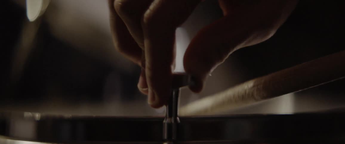 A man tunes a drum