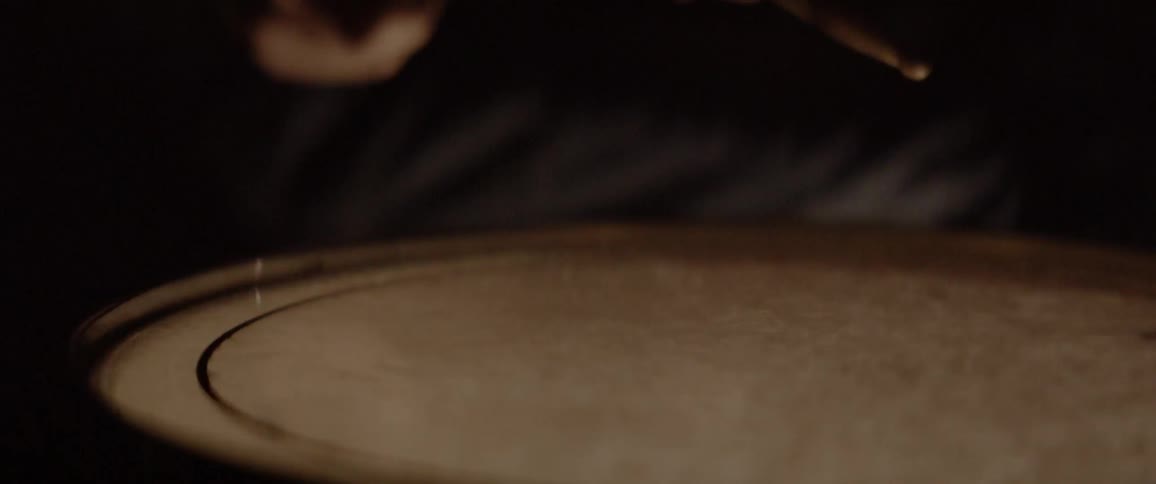 Person is hitting drum with drumsticks