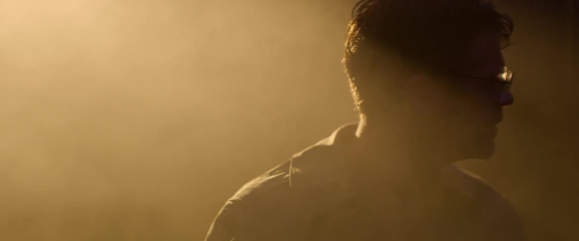 Mist floats around a man with wet glasses