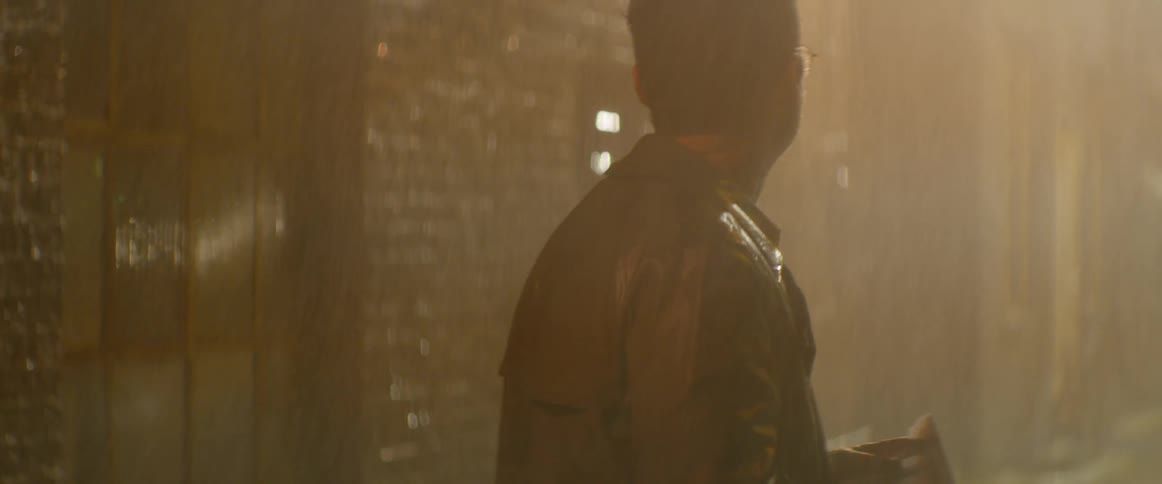 Man stands in the rain looking at a map