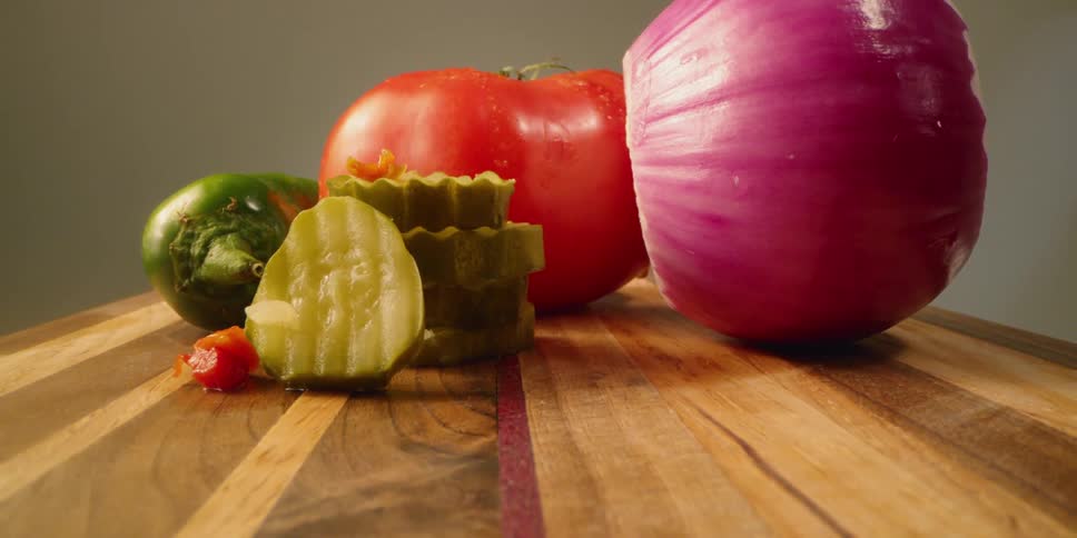 The cutting board has many vegetables