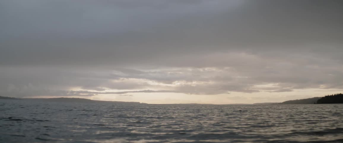 Water rippling in lake on cloudy evening after sunset