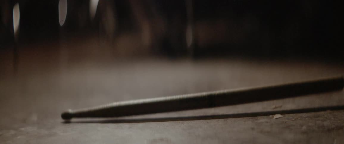 A drumstick bounces off the ground